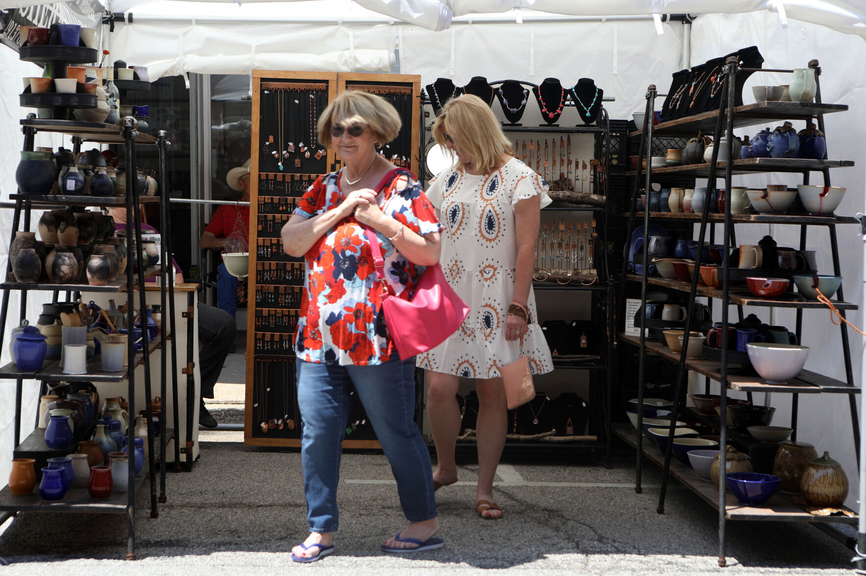 Kristen Light and Linda Paterson exit a pottery booth